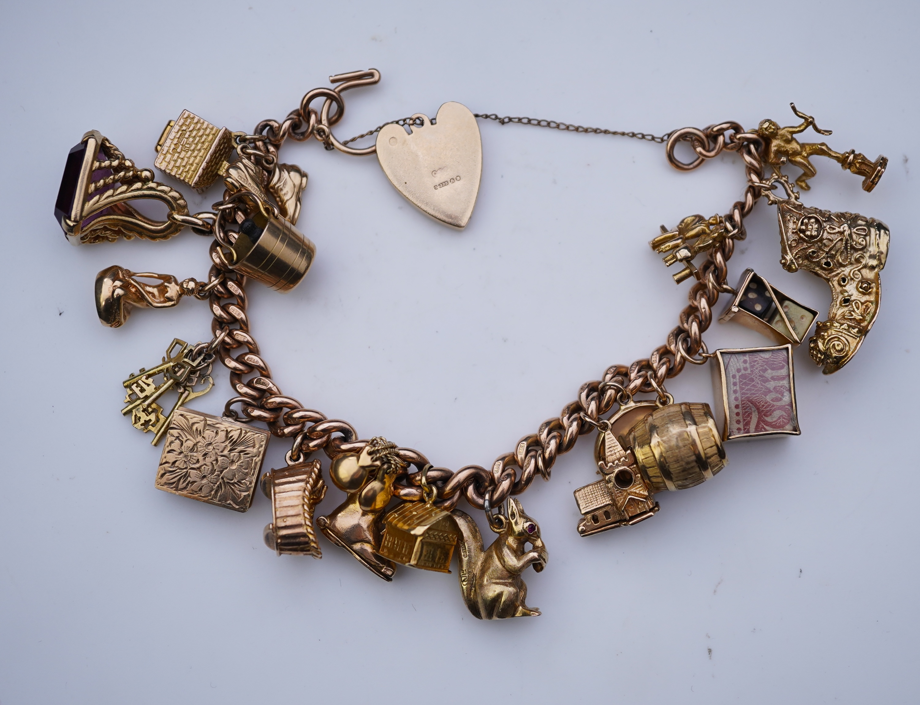 A 9ct gold charm bracelet, mid 20th century